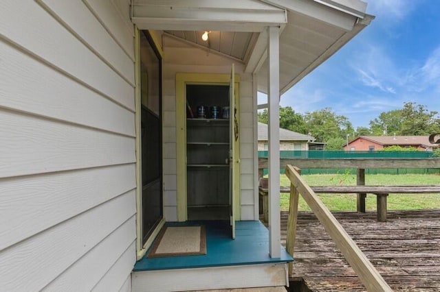 entrance to property featuring fence