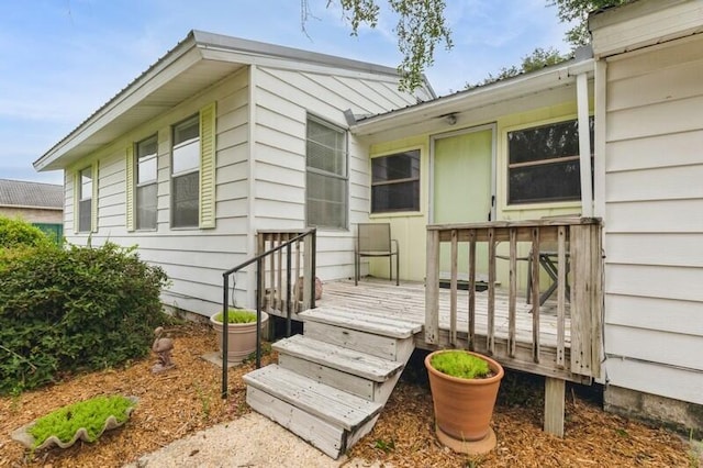 view of exterior entry featuring a deck