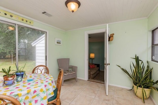 dining area with light tile patterned floors, visible vents, baseboards, and ornamental molding