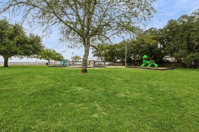 view of yard featuring fence and playground community