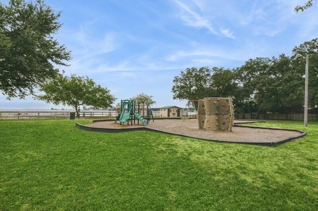 community playground with a lawn and fence