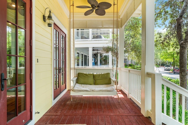 exterior space with a porch and ceiling fan