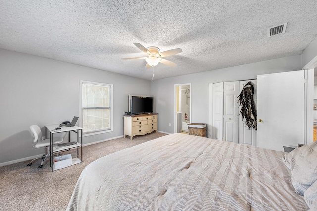 bedroom featuring light colored carpet, a textured ceiling, ensuite bathroom, and ceiling fan