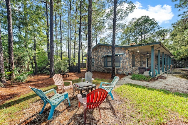 view of yard featuring a fire pit and a patio