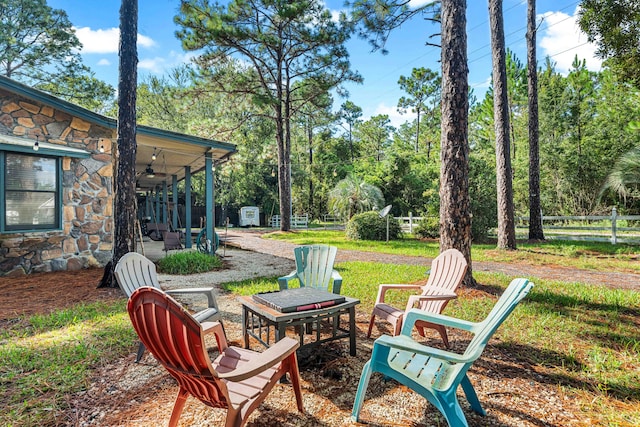 view of yard featuring a fire pit and a patio area