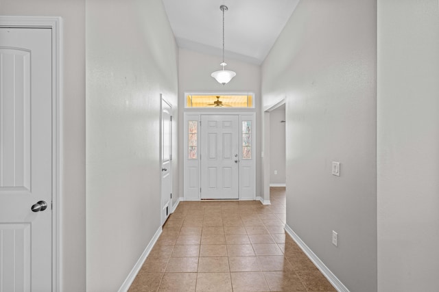 tiled foyer with vaulted ceiling