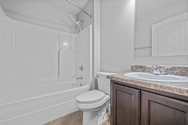 full bathroom featuring washtub / shower combination, vanity, toilet, and tile patterned flooring