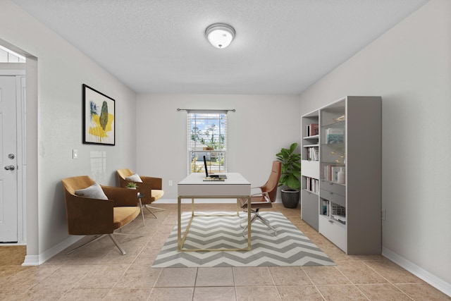 tiled home office with a textured ceiling