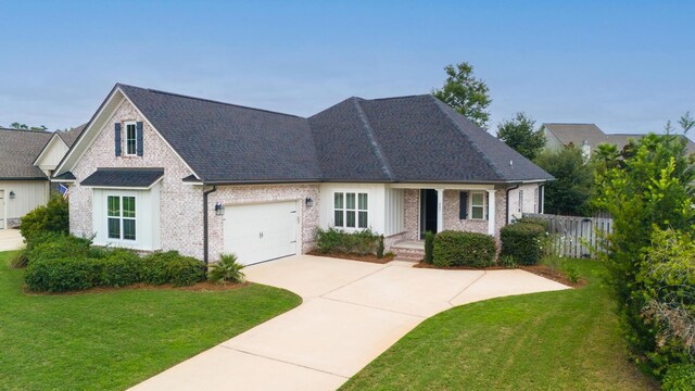 view of front facade with a garage and a front lawn