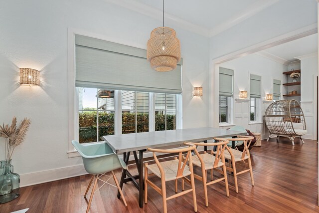 dining space featuring dark wood-type flooring and ornamental molding