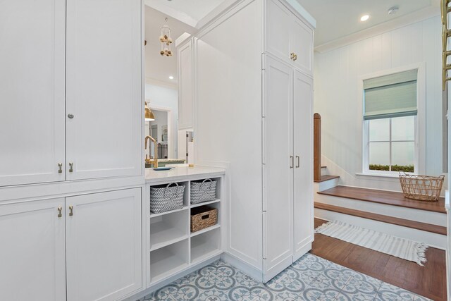 bathroom with hardwood / wood-style flooring, crown molding, and vanity