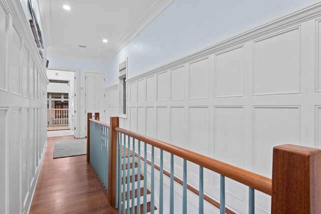 hall featuring dark wood-type flooring and ornamental molding