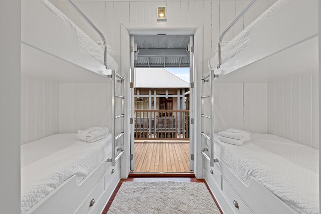 interior space with hardwood / wood-style floors and wood walls