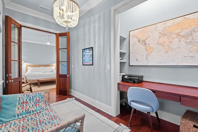 office featuring wood-type flooring, a notable chandelier, and ornamental molding