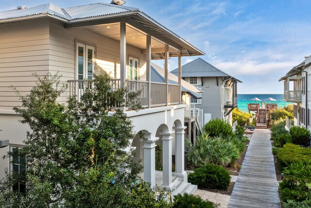 view of side of property featuring a water view and a porch