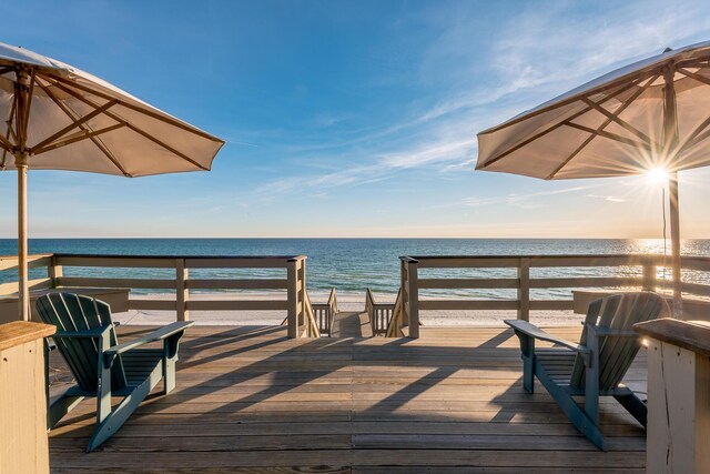 view of dock featuring a view of the beach and a water view