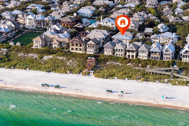 aerial view with a water view and a beach view