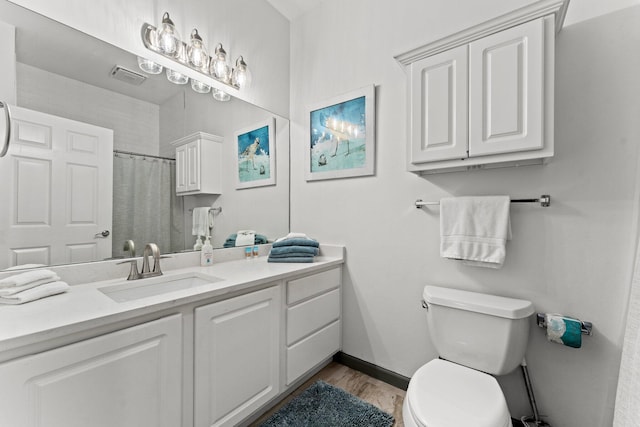 bathroom featuring a shower with curtain, toilet, hardwood / wood-style flooring, and vanity