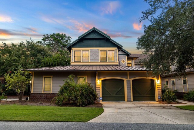 view of front of home with a lawn and a garage