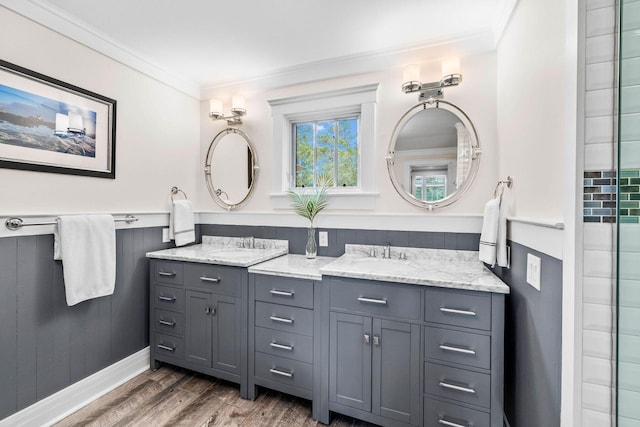 bathroom with vanity, hardwood / wood-style flooring, and ornamental molding