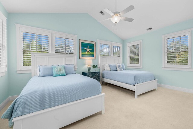 bedroom featuring ceiling fan, light colored carpet, and lofted ceiling