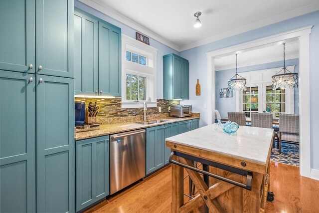 kitchen with pendant lighting, dishwasher, sink, light hardwood / wood-style flooring, and decorative backsplash