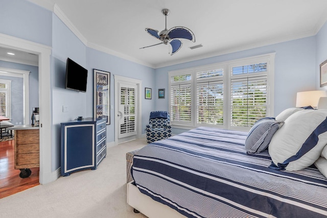 carpeted bedroom with access to outside, ceiling fan, and ornamental molding