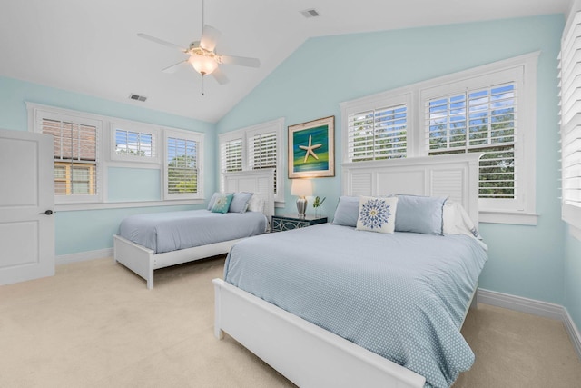 carpeted bedroom with ceiling fan and vaulted ceiling