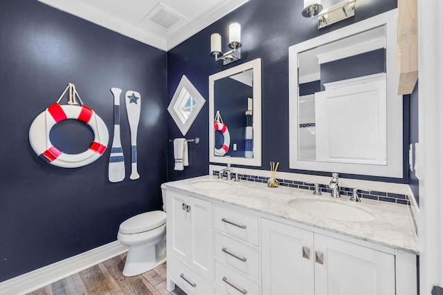 bathroom featuring hardwood / wood-style floors, vanity, toilet, and crown molding