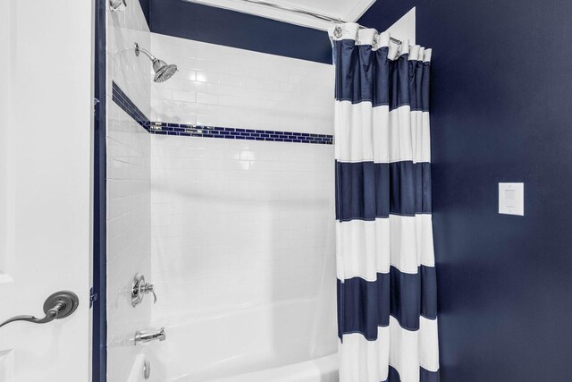 bathroom with shower / bath combination with curtain