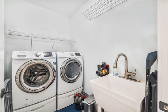 washroom with washing machine and dryer and sink