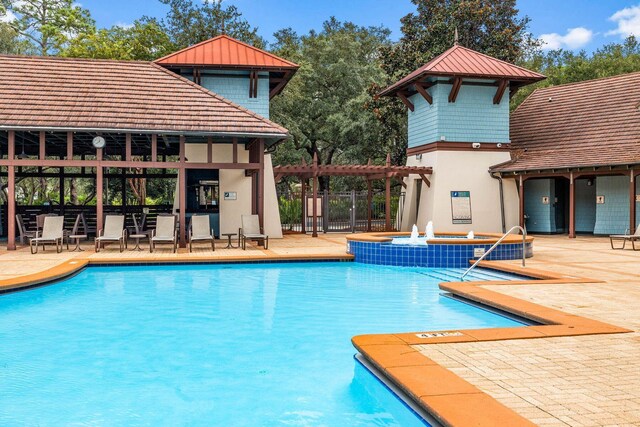 view of swimming pool with a pergola and a patio