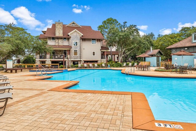 view of swimming pool featuring a patio