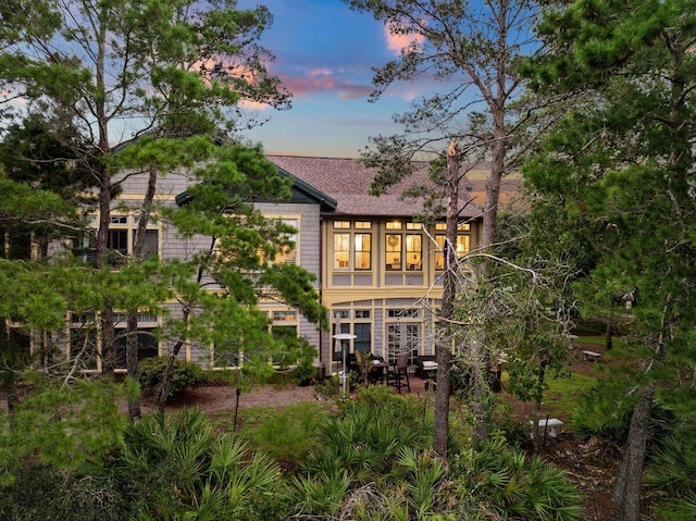 view of back house at dusk