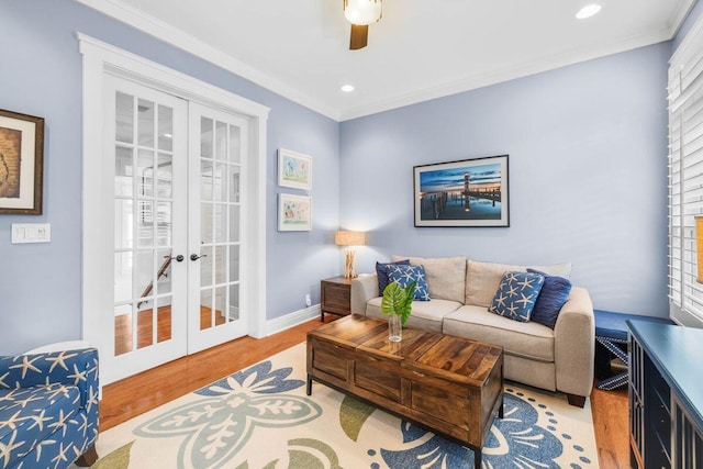 living room featuring crown molding, french doors, ceiling fan, and light hardwood / wood-style flooring