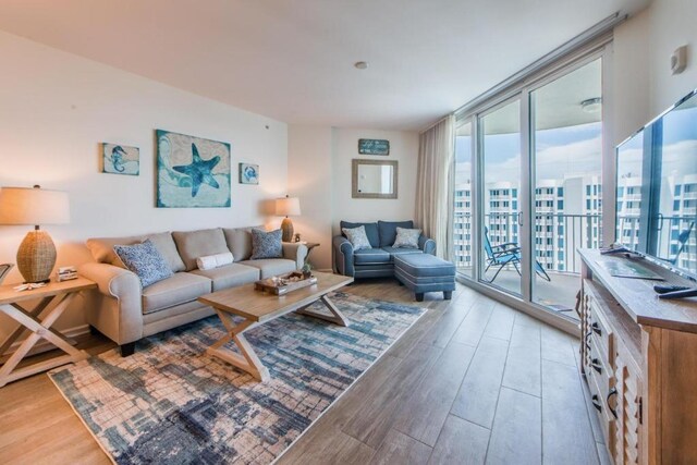 living room with floor to ceiling windows and wood-type flooring