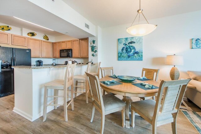 dining area with light wood-type flooring