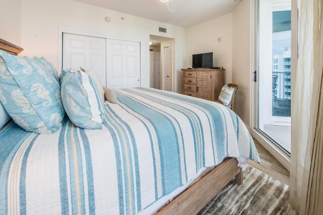 bedroom with ceiling fan, hardwood / wood-style floors, and a closet