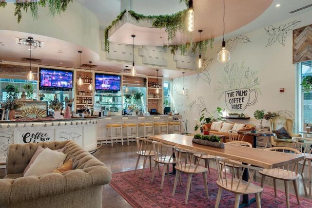 dining area with bar area and concrete flooring