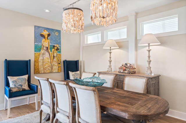 dining room with recessed lighting, a notable chandelier, wood finished floors, and baseboards