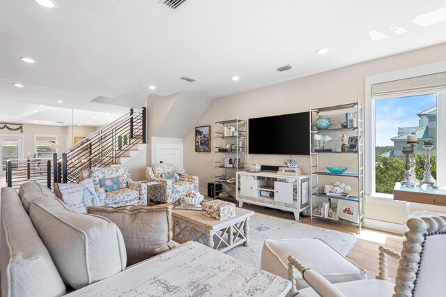 living room with plenty of natural light and light hardwood / wood-style floors