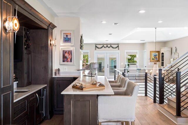 interior space featuring visible vents, recessed lighting, light countertops, dark brown cabinetry, and light wood-type flooring