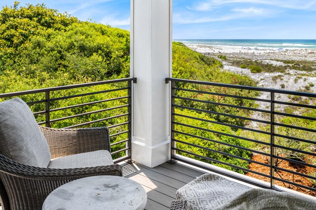 balcony with a beach view and a water view