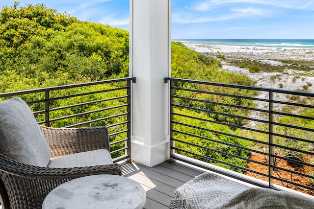 balcony with a water view and a beach view