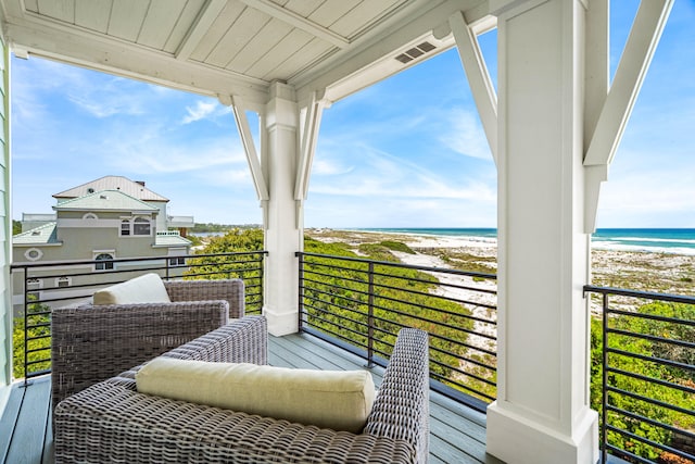 balcony with a beach view and a water view