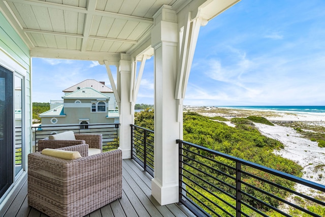 balcony with a beach view and a water view