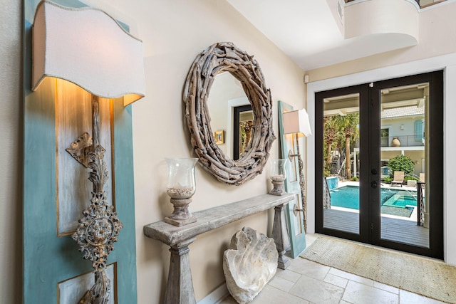 entryway featuring stone tile flooring and french doors
