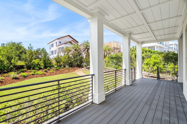deck featuring a porch and a yard