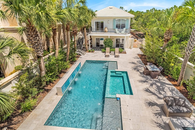 pool featuring a fenced backyard, stairs, and a patio area