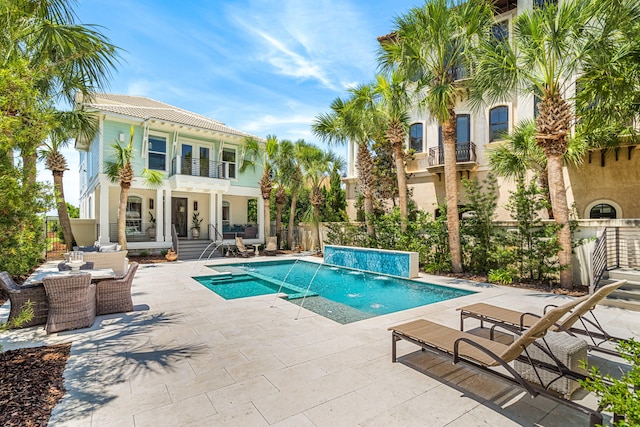 view of swimming pool with a patio and pool water feature